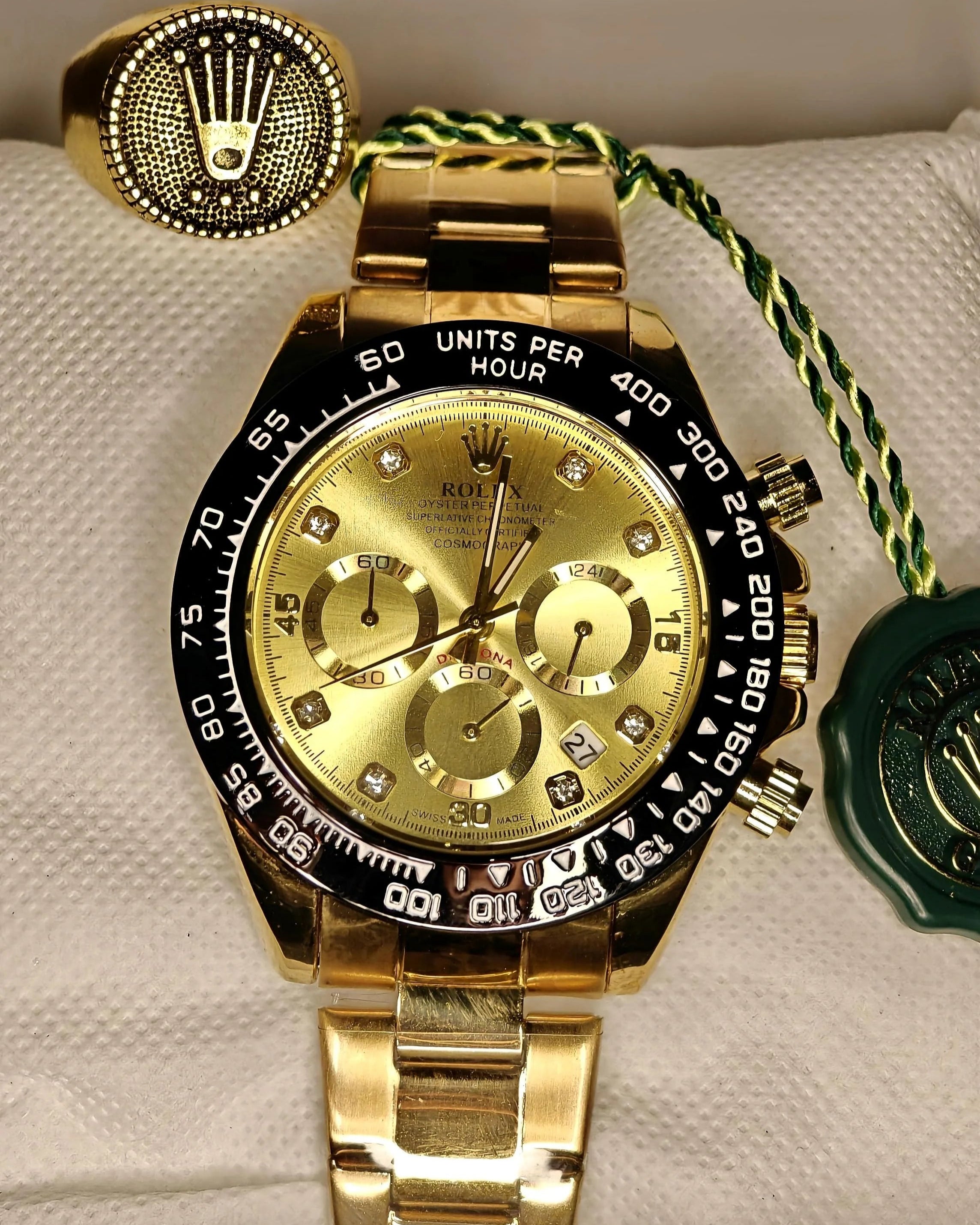 Gold Rolex watch with decorative elements on a white background